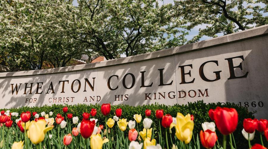 Wheaton College Sign with Tulips in Spring