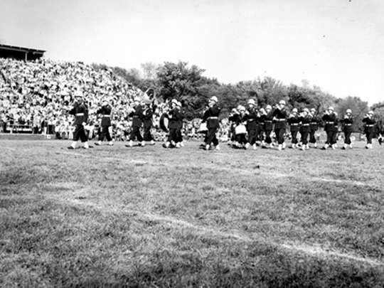 Wheaton College IL ROTC band performs at halftime during 1956 homecoming football game