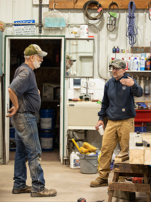 Two men talking in a tool room