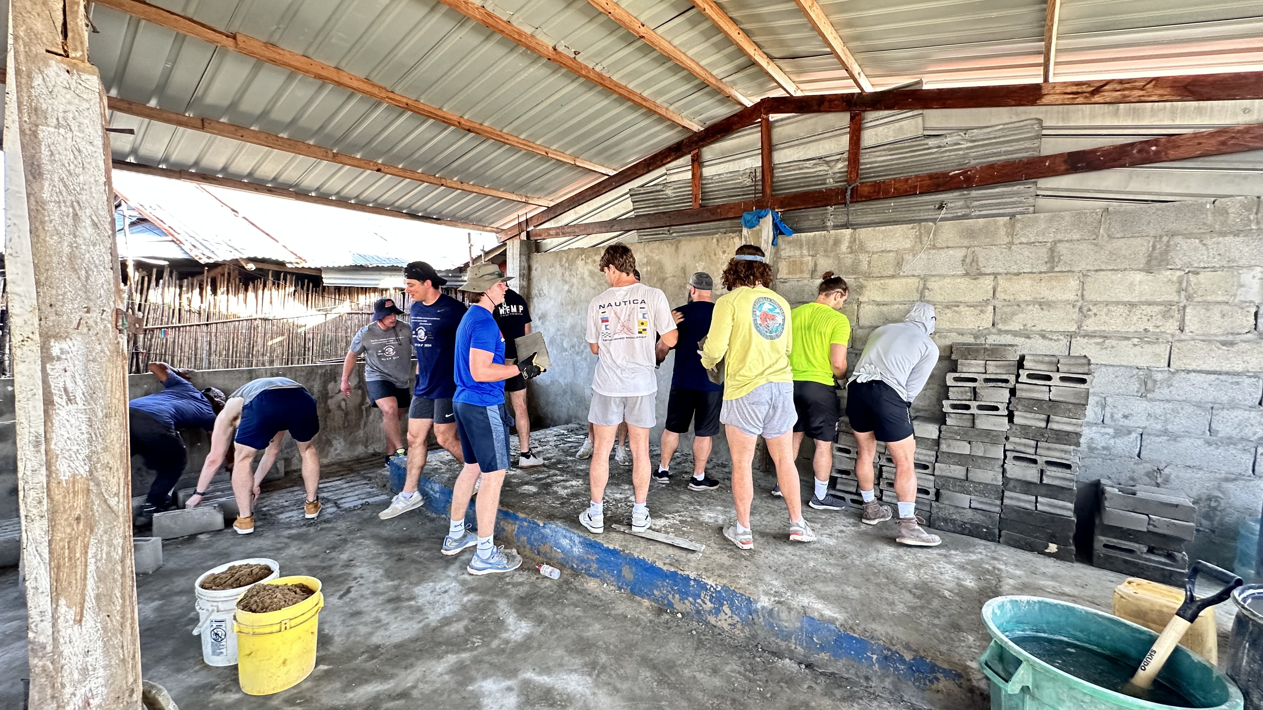 WFMP 2024, Wheaton football players building concrete blocks to rebuild a church on Carti Sugdub island, San Blas Islands, Panama.